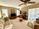 Living room with comfortable seating, a large TV, and sliding doors to patio at 8111 Merrimac Dr, Port Richey, FL 34668