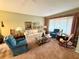 Living room with comfy seating, large windows, and a cozy atmosphere at 8111 Merrimac Dr, Port Richey, FL 34668