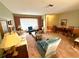 Bright living room with ample seating and large windows at 8111 Merrimac Dr, Port Richey, FL 34668