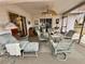 Cozy screened porch with seating area and view of kitchen at 8111 Merrimac Dr, Port Richey, FL 34668