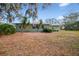 Serene backyard view of the house and surrounding landscape at 8446 Braganza St, Spring Hill, FL 34608