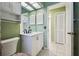 Bathroom with a white vanity and linen closet at 8446 Braganza St, Spring Hill, FL 34608