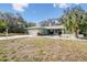 Light green single story home with a two car garage and mature landscaping at 8446 Braganza St, Spring Hill, FL 34608