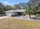 Single-story house with a two-car garage and lush landscaping in front at 8446 Braganza St, Spring Hill, FL 34608