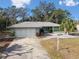 Charming ranch-style home with a two-car garage and manicured lawn at 8446 Braganza St, Spring Hill, FL 34608