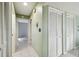 Hallway with light green walls and white closet doors at 8446 Braganza St, Spring Hill, FL 34608