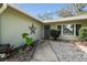 Front entrance with walkway, landscaping, and a star-shaped decoration at 8446 Braganza St, Spring Hill, FL 34608