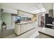 Open kitchen with stainless steel appliances and view to dining area at 8446 Braganza St, Spring Hill, FL 34608