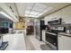 Open kitchen with stainless steel appliances and view into dining area at 8446 Braganza St, Spring Hill, FL 34608