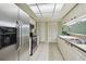 Clean kitchen featuring stainless steel fridge and white cabinets at 8446 Braganza St, Spring Hill, FL 34608