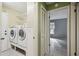 Laundry room with washer, dryer, and built-in shelving at 8446 Braganza St, Spring Hill, FL 34608