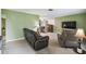 Living room with brown leather furniture, a TV, and carpeted floors at 8446 Braganza St, Spring Hill, FL 34608