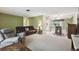 Living room with a gray recliner, sofa, and a view into the dining area at 8446 Braganza St, Spring Hill, FL 34608
