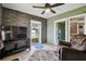 Bright sunroom with sliding glass doors and stone feature wall at 8446 Braganza St, Spring Hill, FL 34608
