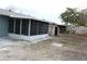 Backyard view with shed and screened porch at 8703 Robilina Rd, Port Richey, FL 34668