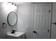 Updated bathroom with vanity, mirror, and modern fixtures at 8703 Robilina Rd, Port Richey, FL 34668