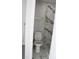 Modern bathroom with marble tile shower and gold fixtures at 8703 Robilina Rd, Port Richey, FL 34668
