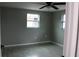 Gray walls, gray tile floor, and a window in bedroom at 8703 Robilina Rd, Port Richey, FL 34668