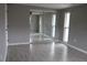 Gray walls, gray tile floors, mirrored closet doors and two windows at 8703 Robilina Rd, Port Richey, FL 34668