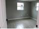 Gray walls, gray tile floor, and a window in bedroom at 8703 Robilina Rd, Port Richey, FL 34668