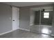 Bright bedroom with tile floors and mirrored closet doors at 8703 Robilina Rd, Port Richey, FL 34668