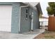 Newly renovated side of the house with light blue brick and white garage at 8703 Robilina Rd, Port Richey, FL 34668