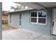 Newly renovated side of the house with light blue brick and white windows at 8703 Robilina Rd, Port Richey, FL 34668