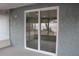 Sliding glass doors leading to a covered patio at 8703 Robilina Rd, Port Richey, FL 34668