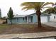 Newly renovated single story home with attached garage and palm tree at 8703 Robilina Rd, Port Richey, FL 34668