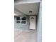 Newly renovated front door with a white door and brick columns at 8703 Robilina Rd, Port Richey, FL 34668
