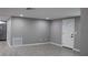 Bright living room with grey walls and tile floors at 8703 Robilina Rd, Port Richey, FL 34668