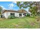 House exterior showcasing a well-maintained backyard and landscaping at 8809 Shoemaker Ln, Hudson, FL 34667