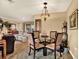 Charming dining area with glass table and comfortable seating for four at 8809 Shoemaker Ln, Hudson, FL 34667