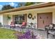 Inviting front porch with comfortable seating and decorative accents at 8809 Shoemaker Ln, Hudson, FL 34667