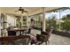 Relaxing screened porch with patio furniture and ceiling fan at 8809 Shoemaker Ln, Hudson, FL 34667