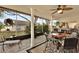 Relaxing screened porch with patio furniture and view of backyard at 8809 Shoemaker Ln, Hudson, FL 34667