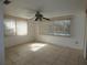 Spacious bedroom with tile floors and ceiling fan at 9241 Cochise Ln, Port Richey, FL 34668