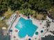 Aerial view of resort-style pool with surrounding lounge chairs at 9338 Clearmeadow Ln, New Port Richey, FL 34655