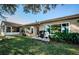 Backyard with patio, grill, and pond view at 9338 Clearmeadow Ln, New Port Richey, FL 34655