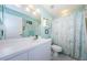 Bright bathroom with white vanity, shower/tub combo and decorative shower curtain at 9338 Clearmeadow Ln, New Port Richey, FL 34655