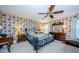 Primary bedroom with floral wallpaper and a large bed at 9338 Clearmeadow Ln, New Port Richey, FL 34655