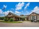 Community clubhouse with covered entryway and golf carts at 9338 Clearmeadow Ln, New Port Richey, FL 34655