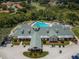 Aerial view of clubhouse with pool and parking at 9338 Clearmeadow Ln, New Port Richey, FL 34655