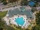 Aerial view of clubhouse and pool area, tennis courts nearby at 9338 Clearmeadow Ln, New Port Richey, FL 34655