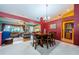 Bright dining room features a wood table with six chairs, hardwood floors, and access to the living room at 9338 Clearmeadow Ln, New Port Richey, FL 34655