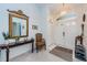Bright entryway with a mirror, chair, and console table at 9338 Clearmeadow Ln, New Port Richey, FL 34655