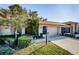 Brick house exterior with a two-car garage, walkway, and landscaping at 9338 Clearmeadow Ln, New Port Richey, FL 34655