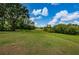 Expansive green golf course with trees and sky at 9338 Clearmeadow Ln, New Port Richey, FL 34655
