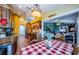 Eat-in kitchen with a view into Gathering room, featuring wood cabinets and granite counters at 9338 Clearmeadow Ln, New Port Richey, FL 34655