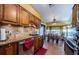 Modern kitchen boasts granite countertops, stainless steel appliances, and ample wood cabinets at 9338 Clearmeadow Ln, New Port Richey, FL 34655